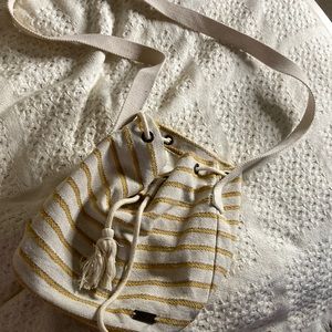 It’s a yellow and white bag. It looks small but actually can fit a lot.